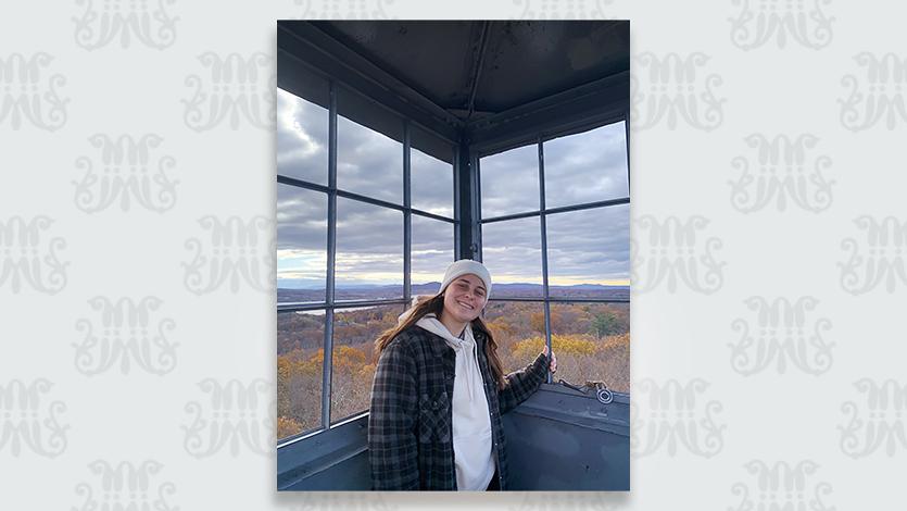 Image of Haley Merrill '24 on top of the Ferncliff Tower